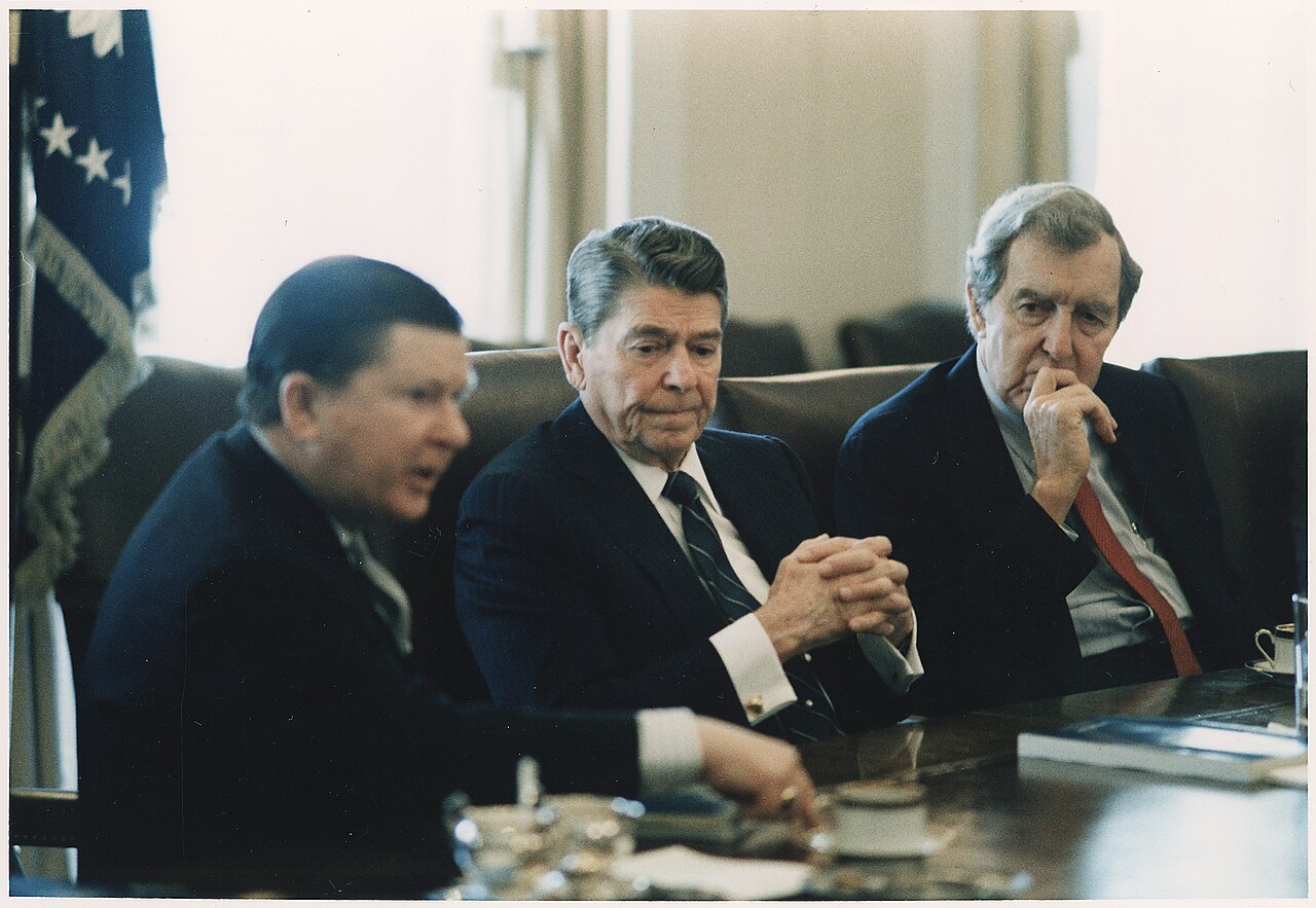 President Reagan receives the Tower Commission Report in the White House Cabinet Room, 1987.