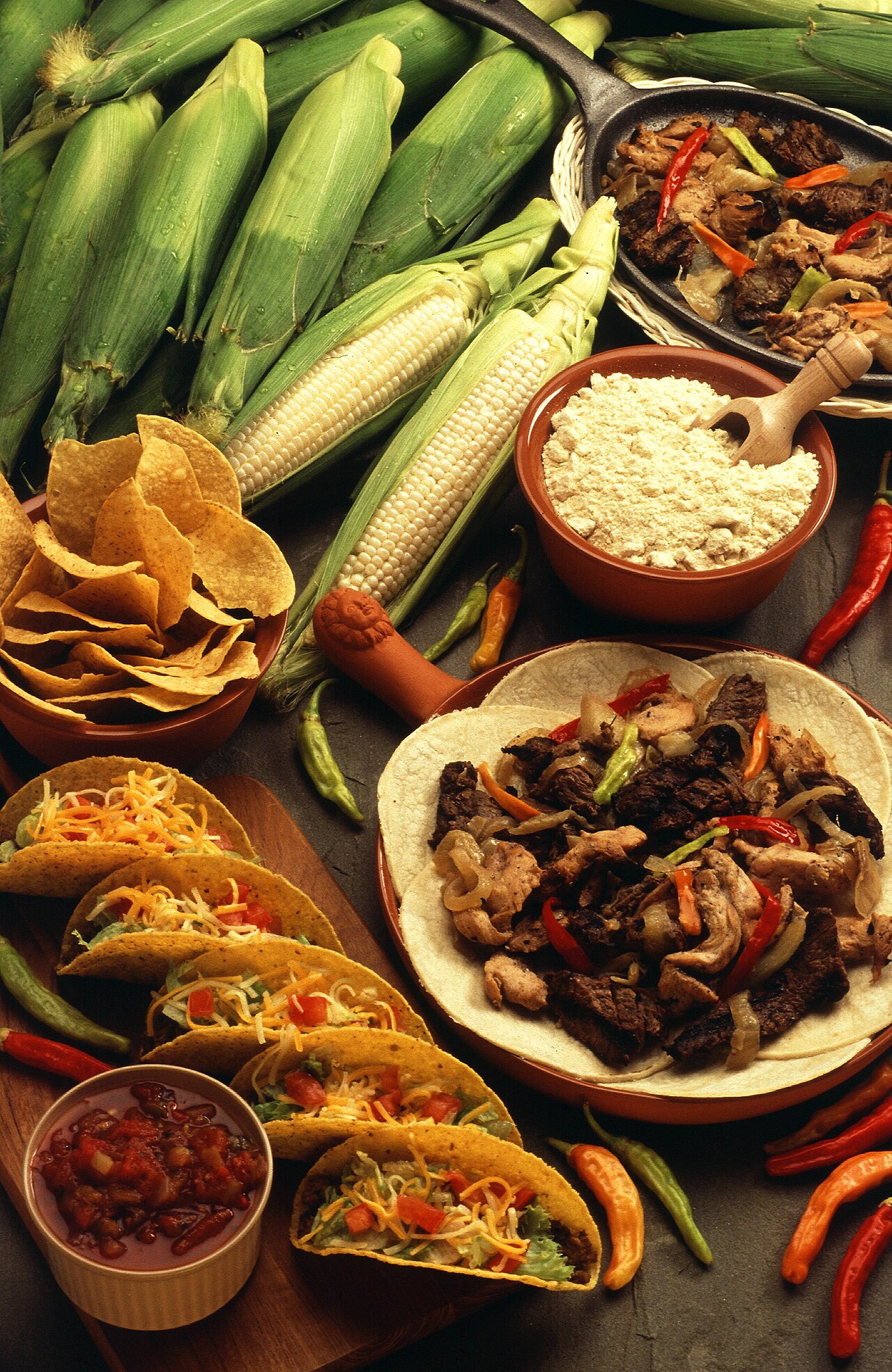 An assortment of Tex-Mex ingredients and dishes, including tacos, chips, and salsa.