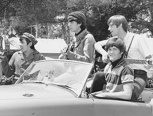 The Monkees riding together in a car in 1965.
