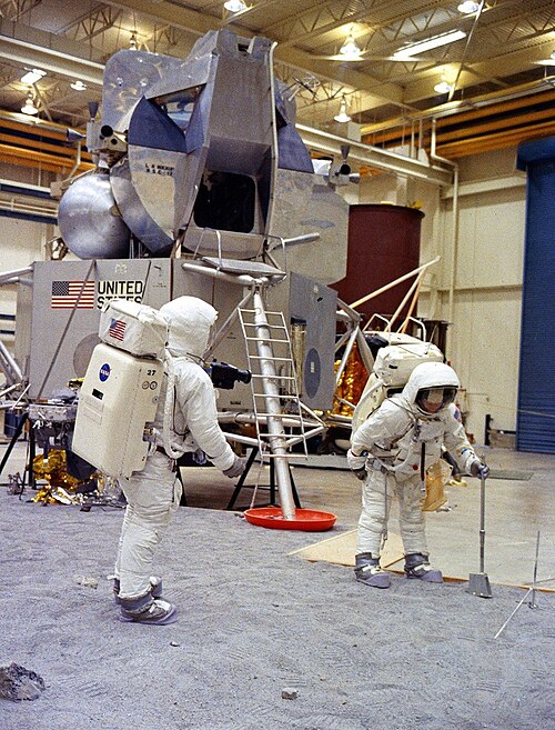 Neil Armstrong and Buzz Aldrin train on a simulated lunar surface in Building 9, April 1969.