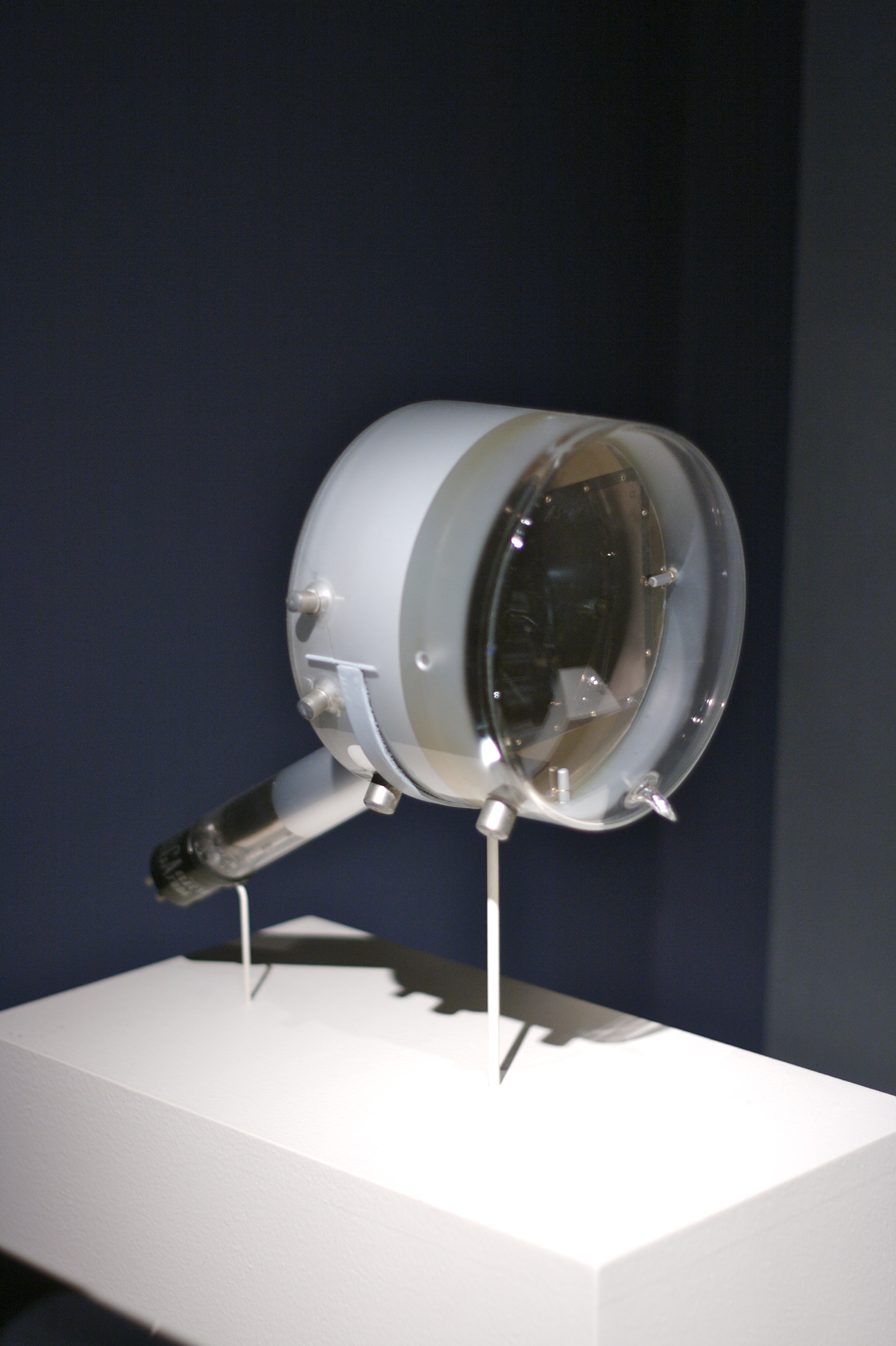 Early television camera tube component displayed on a pedestal.